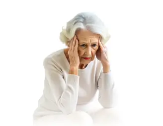 Elderly woman sitting with a distressed expression, holding her head in her hands.