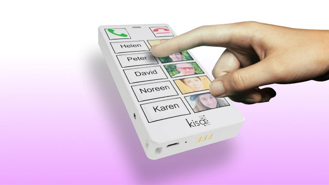 Close-up of a hand pressing the 'Peter' contact button on a KISA Phone, showcasing the large, easy-to-press buttons with names and photos.