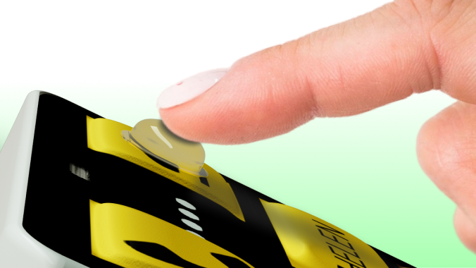 Close-up of a finger pressing a rubber bump on a KISA Phone.