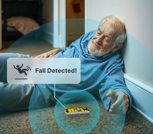 Elderly man sitting on stairs after a fall, surrounded by digital icons indicating the monitoring system in action