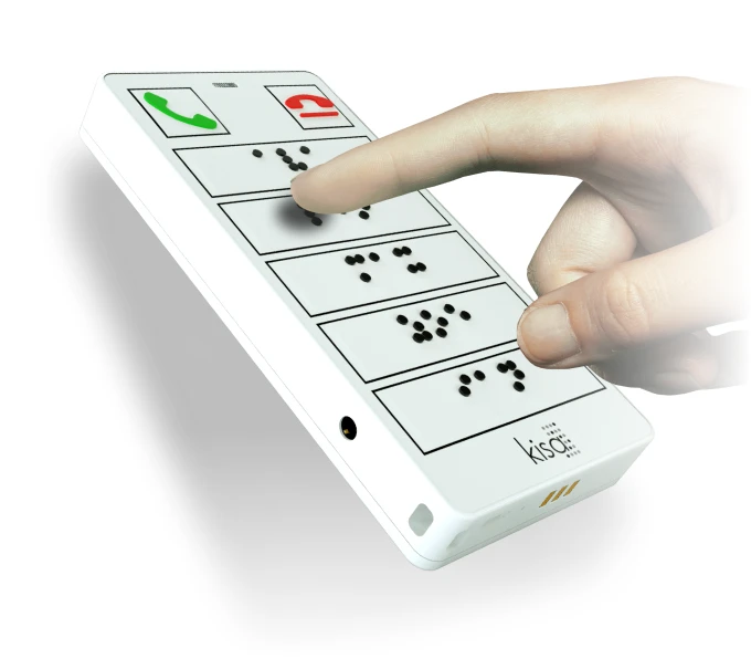 A hand pressing a button on a KISA Phone, which features Braille labels on large, high-contrast buttons for easy accessibility.