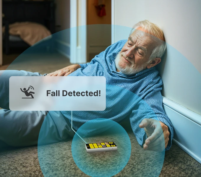 Elderly man sitting on stairs after a fall, surrounded by digital icons indicating the monitoring system in action