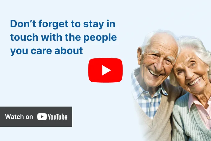 Elderly couple smiling together, with the man wearing a checkered shirt and the woman a white cardigan, under the text 'KISA Phone for elderly' and a 'Watch on YouTube' button.